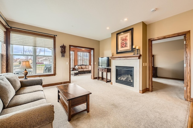 20620 Everton Way N, Forest Lake, MN 55025 - living area featuring light carpet, a glass covered fireplace, baseboards, and recessed lighting
