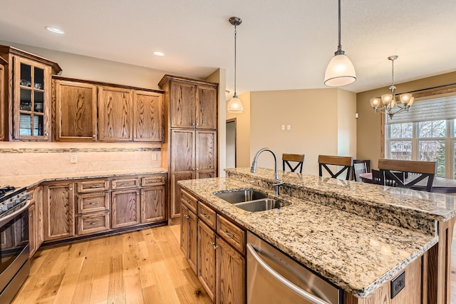 20620 Everton Way N, Forest Lake, MN 55025 - kitchen with a sink, stainless steel appliances, light wood-style flooring, tasteful backsplash, and an island with sink