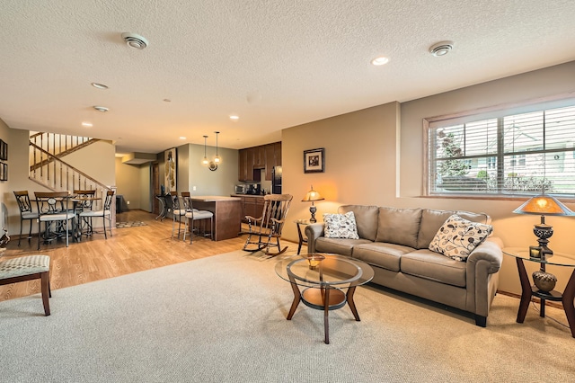 20620 Everton Way N, Forest Lake, MN 55025 - living room featuring stairway, a textured ceiling, light wood-type flooring, light carpet, and recessed lighting