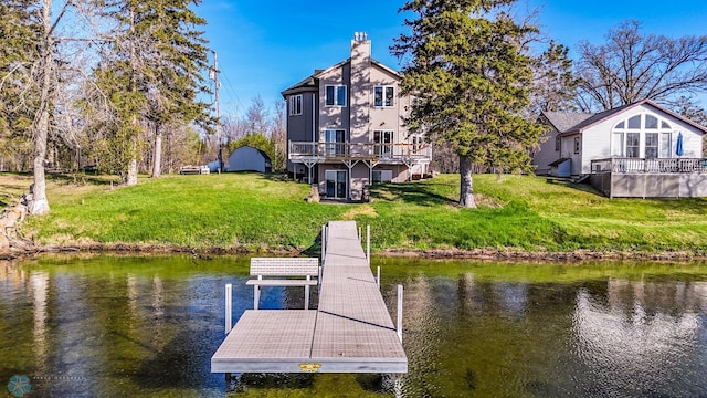 29972 293rd St, Little Elbow Twp, MN 56589 - dock featuring a lawn and a deck with water view