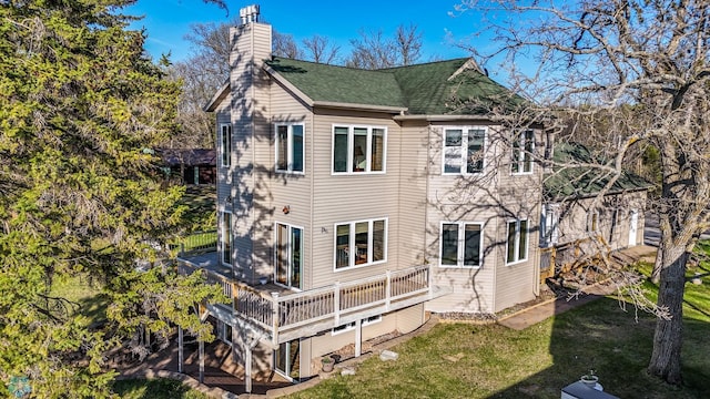 29972 293rd St, Little Elbow Twp, MN 56589 - rear view of house featuring a chimney, a yard, a deck, and a shingled roof