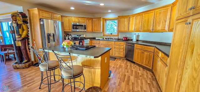 29972 293rd St, Little Elbow Twp, MN 56589 - kitchen with appliances with stainless steel finishes, a sink, light wood finished floors, dark countertops, and recessed lighting