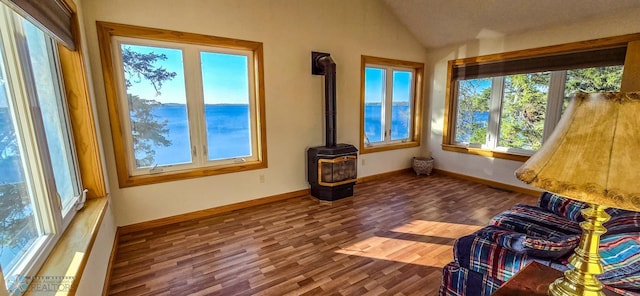 29972 293rd St, Little Elbow Twp, MN 56589 - unfurnished sunroom featuring a wood stove, lofted ceiling, and a water view