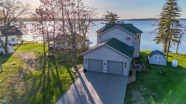 29972 293rd St, Little Elbow Twp, MN 56589 - view of front of property with a storage unit, driveway, a water view, and a front yard