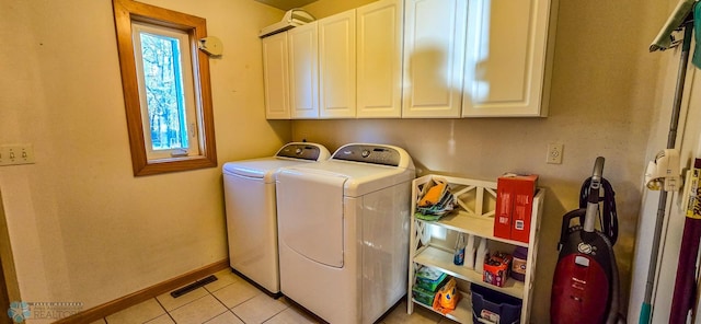 29972 293rd St, Little Elbow Twp, MN 56589 - clothes washing area with washing machine and clothes dryer, cabinet space, light tile patterned floors, and baseboards