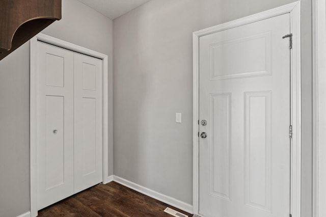 entrance foyer featuring visible vents, baseboards, and dark wood-style flooring
