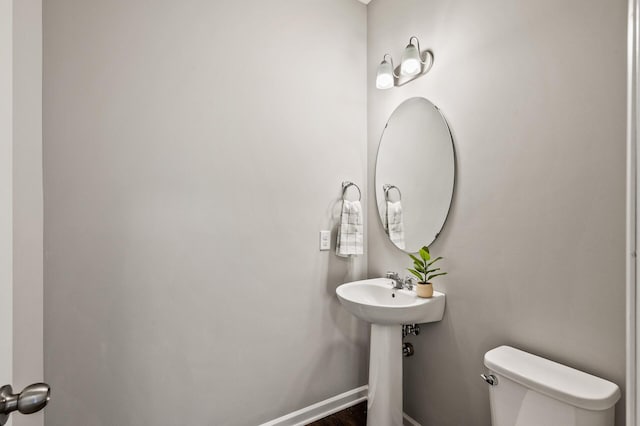 bathroom with toilet and baseboards