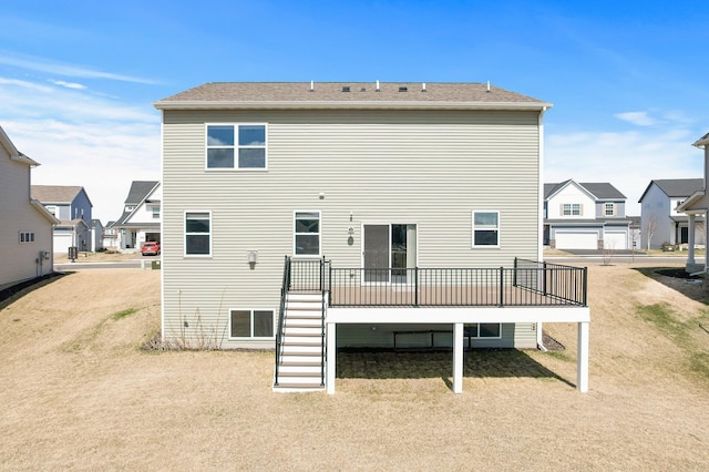 rear view of house with stairway, a residential view, and a deck