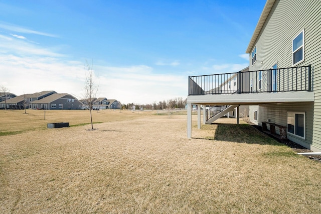 view of yard with a wooden deck, a residential view, and stairway