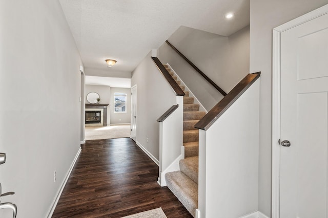 20147 79th Ave, Corcoran, MN 55340 - entryway featuring baseboards, wood finished floors, stairs, a glass covered fireplace, and recessed lighting