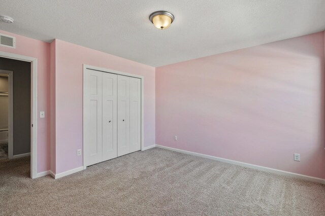 20147 79th Ave, Corcoran, MN 55340 - unfurnished bedroom with carpet floors, baseboards, and a textured ceiling
