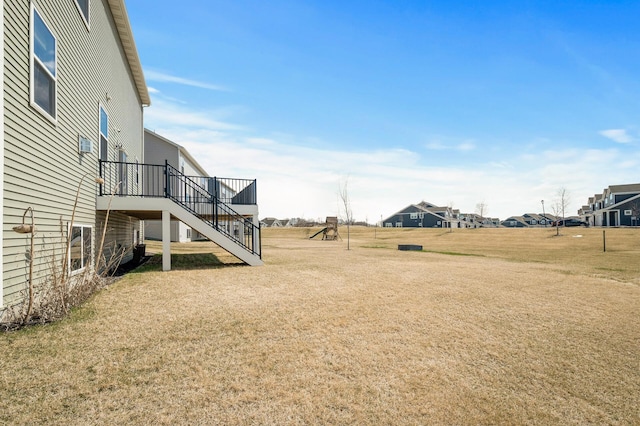 20147 79th Ave, Corcoran, MN 55340 - view of grassy yard featuring stairs, a deck, and a residential view