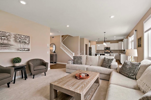 living area featuring recessed lighting, stairs, baseboards, and visible vents