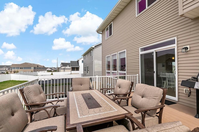 view of patio / terrace featuring fence, a residential view, and a deck