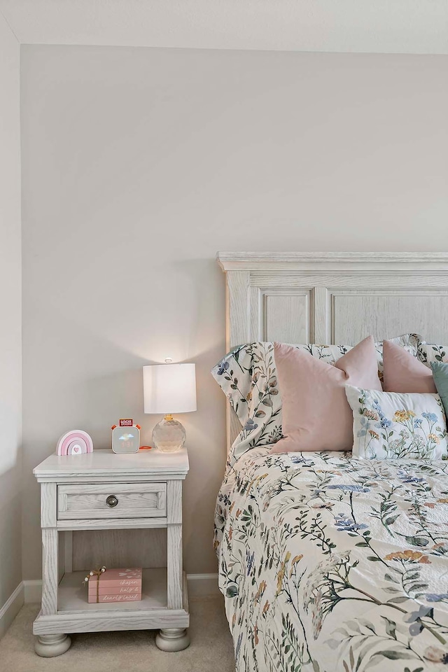 carpeted bedroom with baseboards