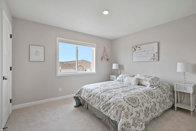 carpeted bedroom featuring baseboards