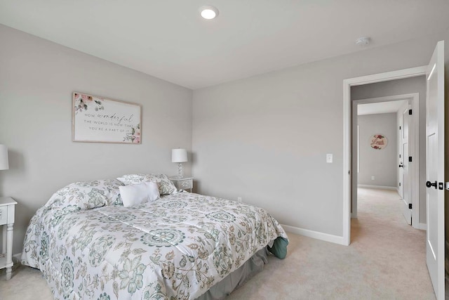 bedroom with baseboards and light carpet