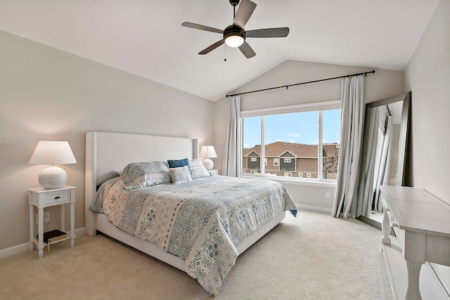bedroom with baseboards, a ceiling fan, lofted ceiling, and light carpet