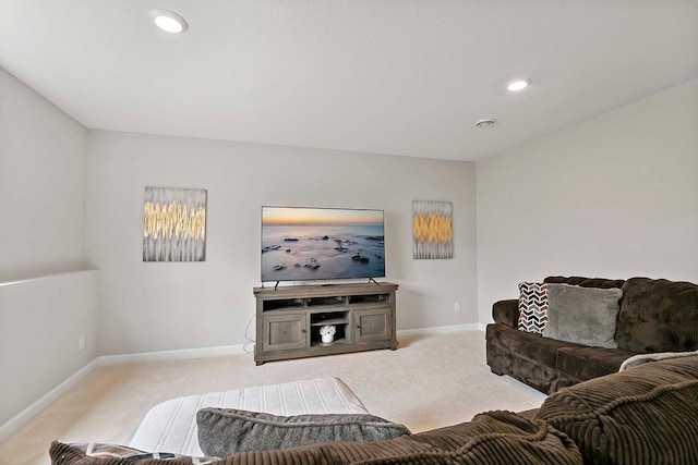 carpeted living area featuring recessed lighting and baseboards