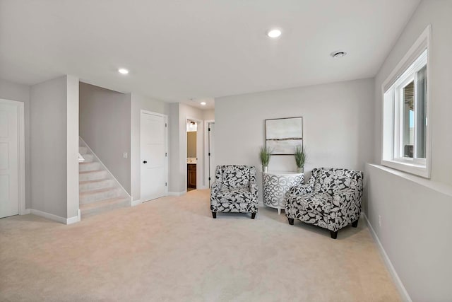 sitting room featuring carpet floors, recessed lighting, baseboards, and stairway