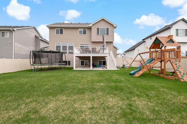 back of house with a trampoline, a patio area, a fenced backyard, a playground, and stairs