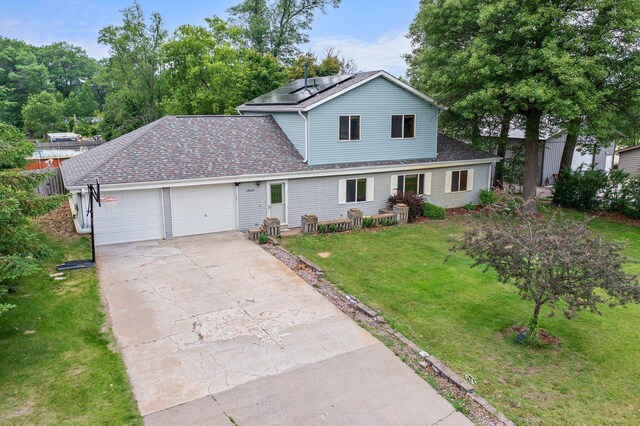 28008 Lake Diann Rd, Baldwin Twp, MN 55398 - traditional home with a garage, a front yard, roof mounted solar panels, concrete driveway, and a shingled roof