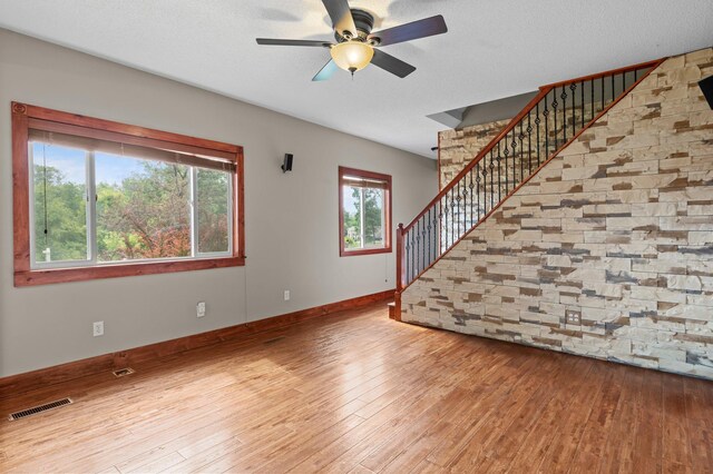 28008 Lake Diann Rd, Baldwin Twp, MN 55398 - unfurnished living room with stairs, hardwood / wood-style floors, and ceiling fan