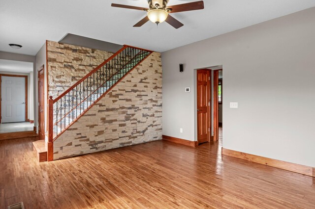 28008 Lake Diann Rd, Baldwin Twp, MN 55398 - unfurnished living room with ceiling fan, wood finished floors, and stairway