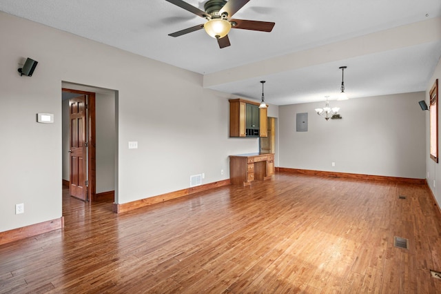 28008 Lake Diann Rd, Baldwin Twp, MN 55398 - unfurnished living room featuring light wood finished floors, a chandelier, a ceiling fan, and electric panel