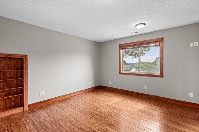 28008 Lake Diann Rd, Baldwin Twp, MN 55398 - empty room featuring wood finished floors and a textured ceiling