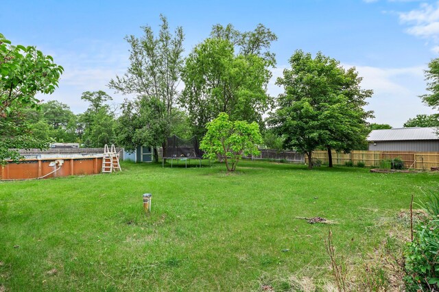 28008 Lake Diann Rd, Baldwin Twp, MN 55398 - view of yard with a trampoline and an outdoor pool