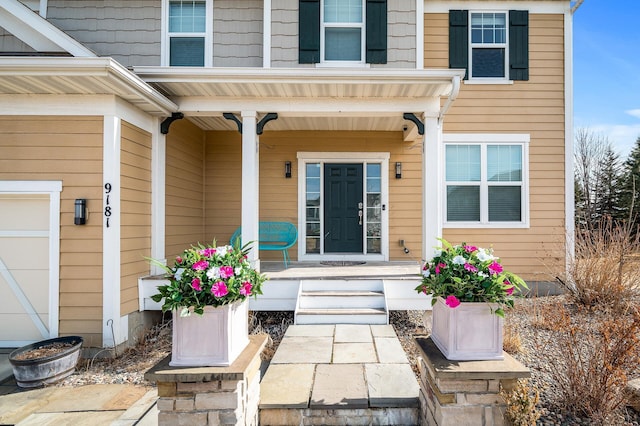 view of exterior entry with covered porch