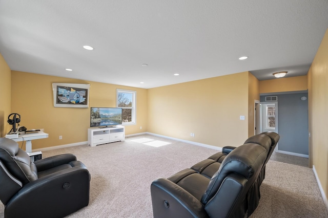carpeted living area with baseboards and recessed lighting