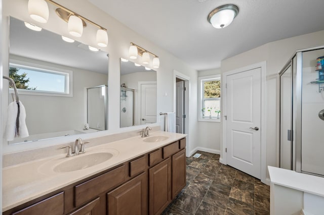 full bath with plenty of natural light, a sink, and a shower stall