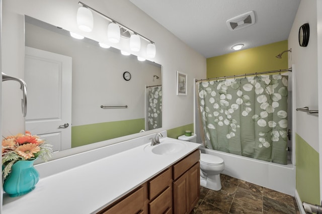 bathroom with stone finish floor, visible vents, shower / tub combo, vanity, and toilet