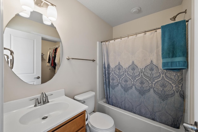 full bathroom featuring vanity, toilet, a textured ceiling, and shower / tub combo with curtain