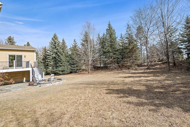 view of yard featuring stairway and a deck
