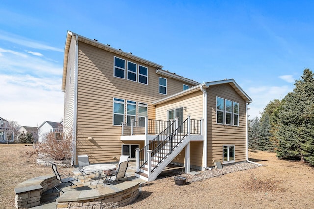 rear view of house with stairs and a patio area