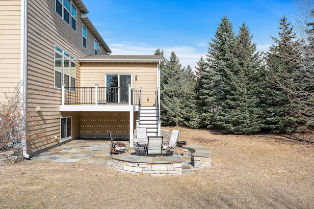 back of property featuring stairway and a patio
