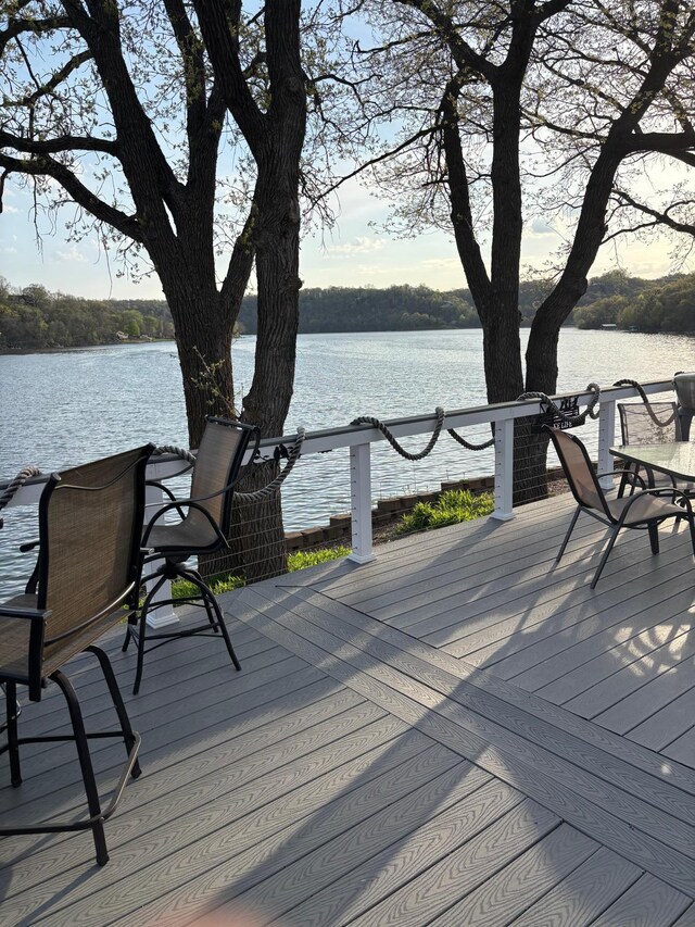 wooden terrace featuring a water view