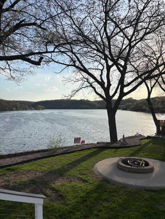 view of yard featuring a water view and an outdoor fire pit