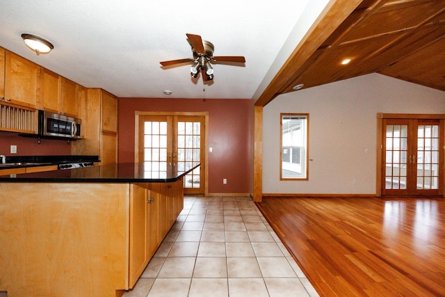 kitchen featuring french doors, stainless steel microwave, dark countertops, baseboards, and ceiling fan