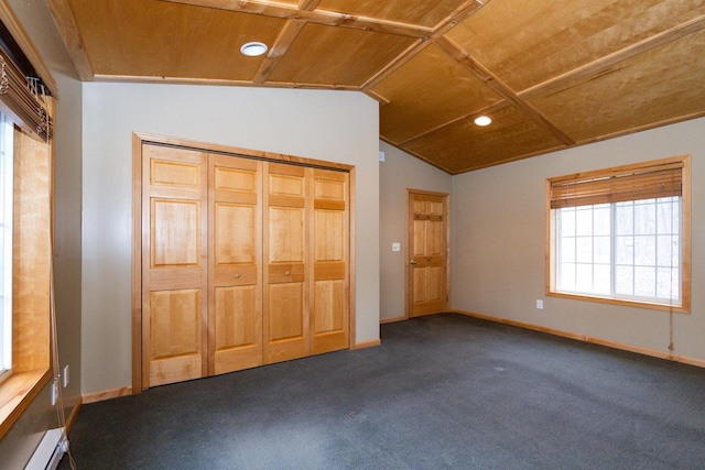 unfurnished bedroom with dark carpet, baseboards, wood ceiling, and vaulted ceiling