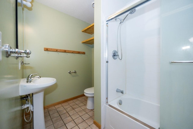 bathroom with a sink, toilet, baseboards, tile patterned flooring, and shower / tub combination