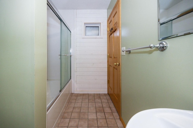 bathroom featuring combined bath / shower with glass door and tile patterned flooring