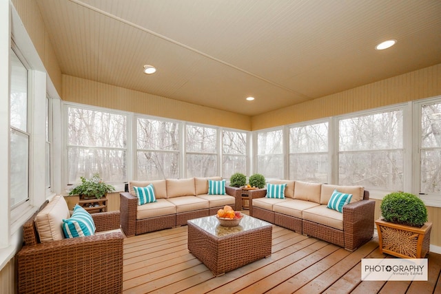 sunroom / solarium featuring wood-type flooring, a wealth of natural light, and recessed lighting