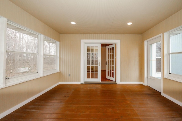 unfurnished sunroom featuring plenty of natural light and french doors