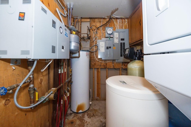 utility room with electric panel, water heater, and gas water heater