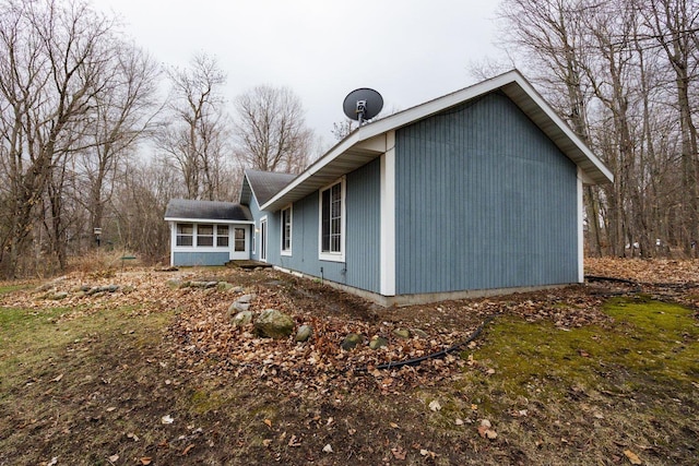 view of side of home featuring a sunroom