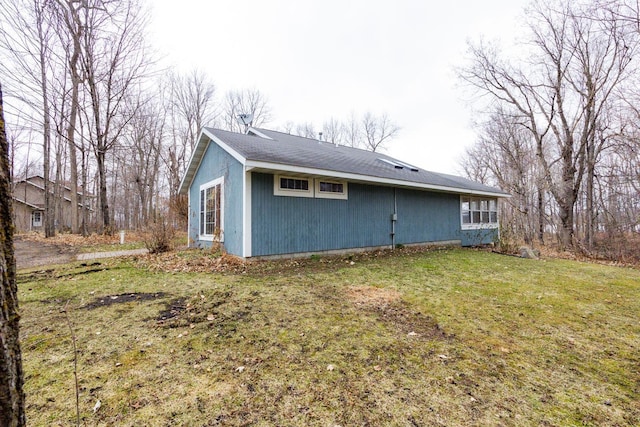 view of side of property with a yard